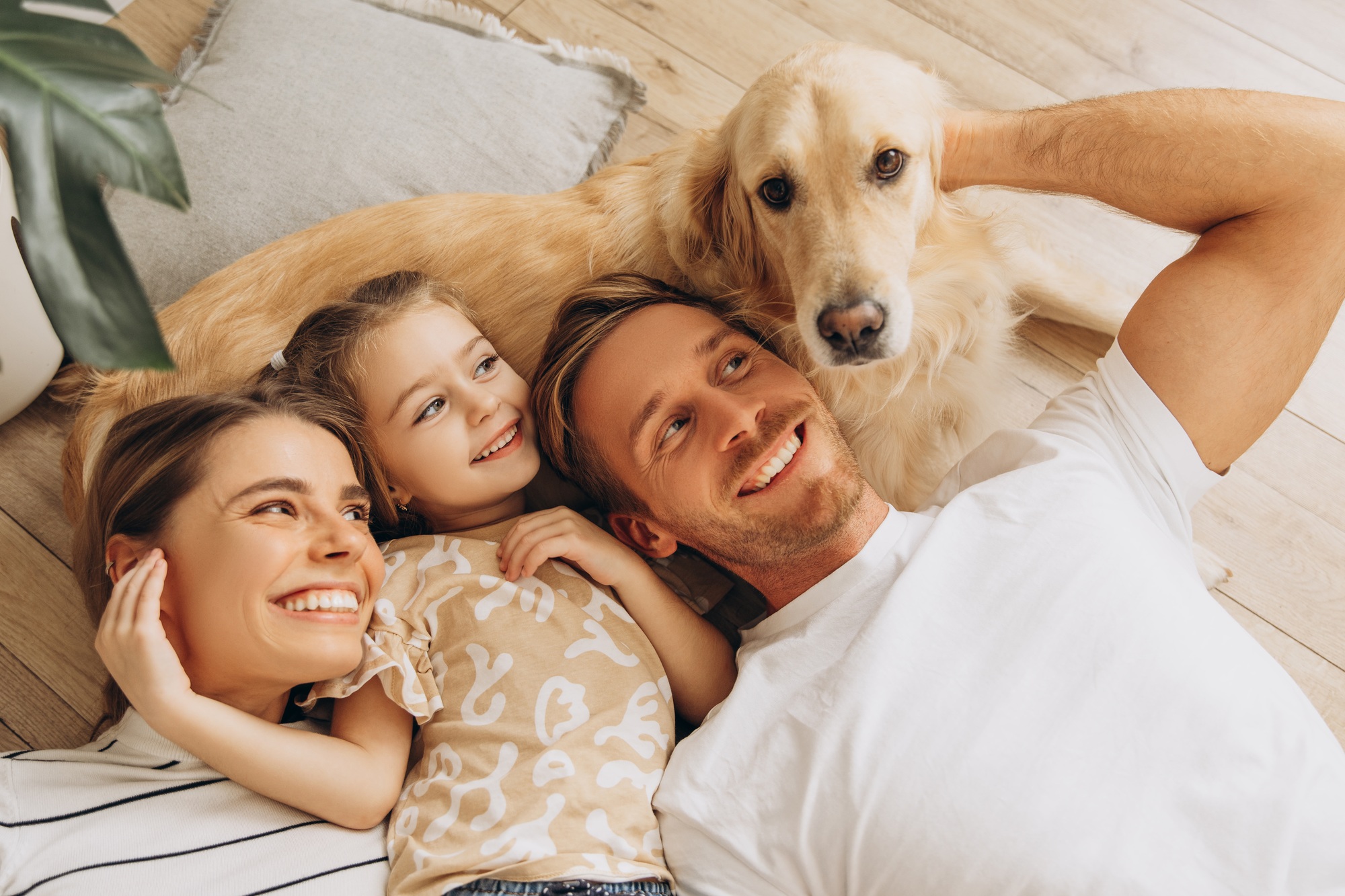 Portrait of happy family, beautiful mother, father, cute little daughter playing together with dog - Loan Select Australia Portrait of happy family, beautiful mother, father, cute little daughter playing together with dog